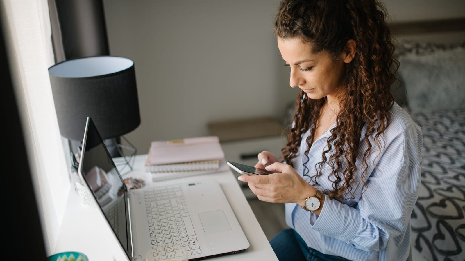 Managing a property purchase remotely on a laptop and phone