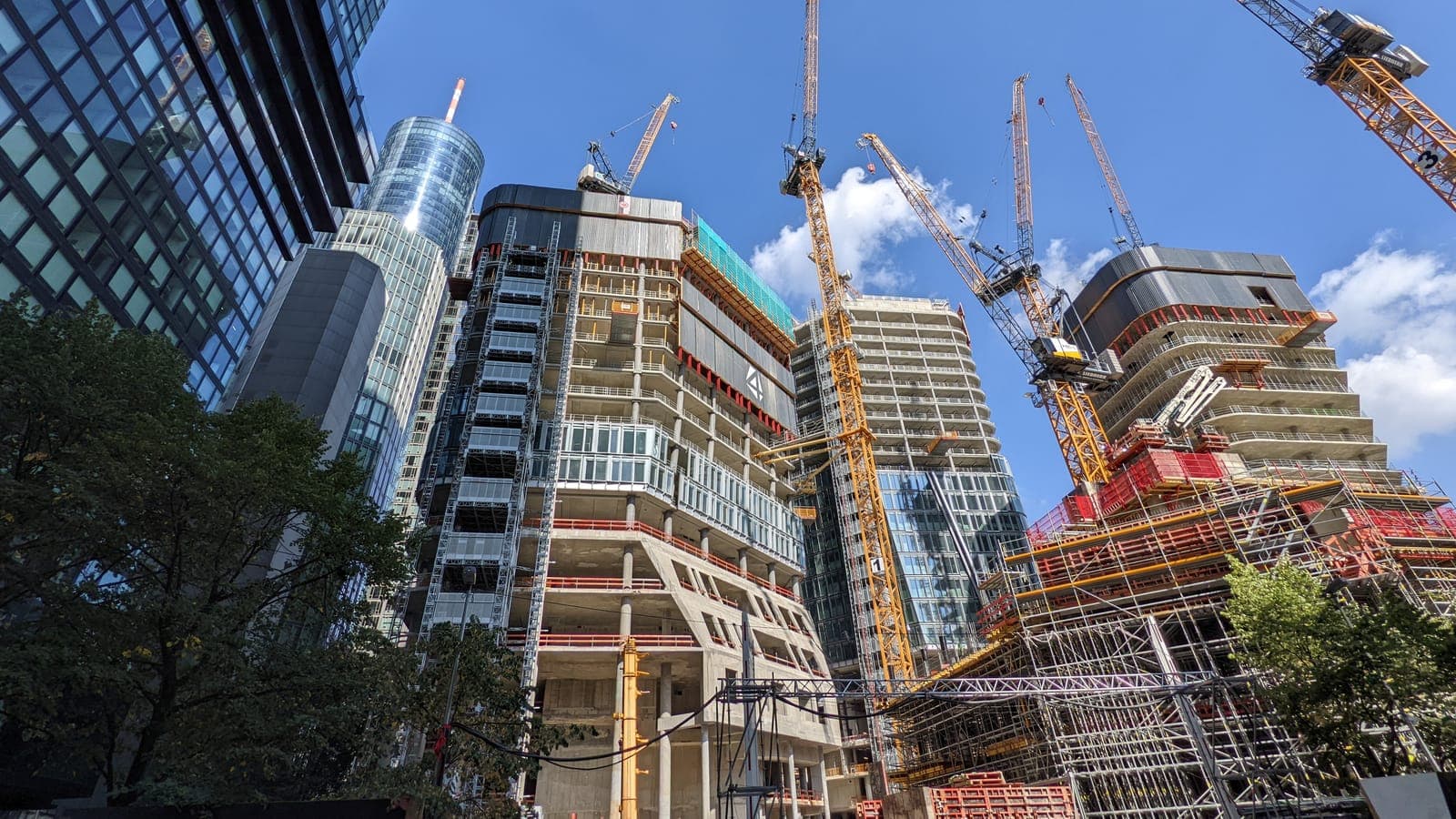 High-rise buildings under construction with tower cranes
